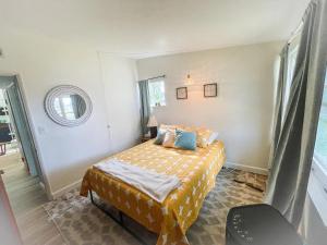 a small bedroom with a bed and a window at NEW! Mid-Century Modern Themed Family Home! in Vermilion