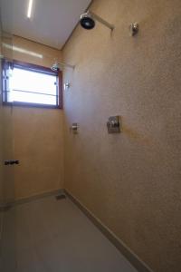 a bathroom with a shower and a window on the wall at Solar Da Serra Tiradentes in Tiradentes