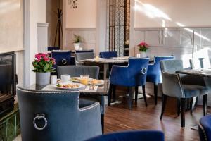 a restaurant with tables and chairs with food on them at Villa Sedan - Destigo Hotels in Sopot