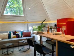 a living room with a couch and a table with chairs at La Cabane perchée de la Mure in Bongheat