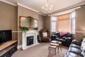 a living room with a couch and a fireplace at Free Parking Stylish House Near Humber Bridge in Barton upon Humber