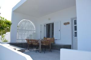 a patio with a table and chairs on a house at Summer Residence in Provatas
