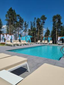 a pool with chaise lounge chairs at 103 View Park Hotel & SPA in Panichishte