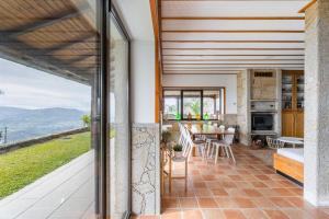 an open kitchen and dining room with a table and chairs at Casa Letrigo in Arcos de Valdevez