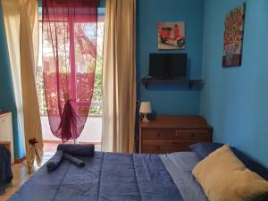 a bedroom with a bed in front of a window at La capannina cilento cam 12 in San Marco di Castellabate