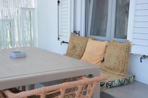 a table and a couch with pillows on a porch at Summer Residence in Provatas