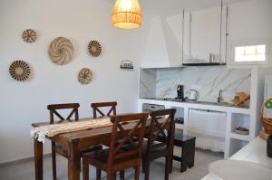 a kitchen with a wooden table and chairs at Summer Residence in Provatas