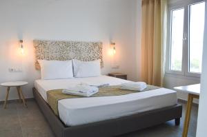 a bedroom with a bed with two towels on it at Summer Residence in Provatas