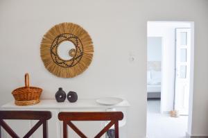 a mirror on a wall above a table with chairs at Summer Residence in Provatas