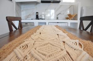 a knitted rug on a wooden table in a kitchen at Summer Residence in Provatas