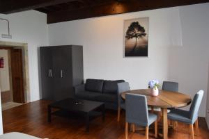 a living room with a table and a couch at Monasterio de Moraime in Muxia