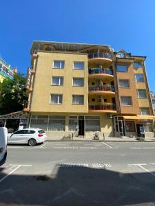 a tall building with a car parked in front of it at Family Hotel Diana in Pomorie