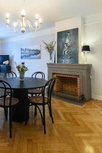 a dining room with a table and a fireplace at HoMade B&B, Gamla Stan in Norrköping