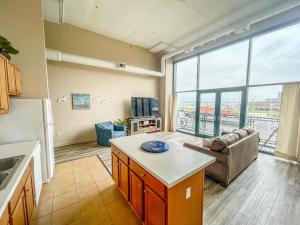 a kitchen and living room with a large window at Condo with Lake & Cedar Point Views From Balcony. in Sandusky