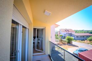 a balcony with a view of a street at Holiday Home Marino in Zmijavci