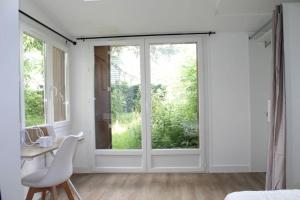 a bedroom with a window and a desk and a chair at Zenitude Place in Margny-lès-Compiègne