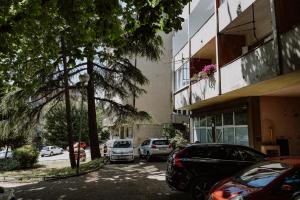 a parking lot with cars parked in front of a building at Tara in Rijeka