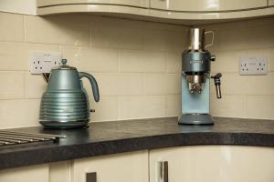 a kitchen counter with a mixer and a tea kettle at Avernish Lodge-Luxury Self Catering in Kirkton