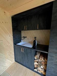 a bathroom with a sink in a room at Obytný kontejner Cabin Stars in Zátor