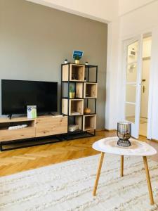 a living room with a tv and a coffee table at Lovely apartment in the heart of the city center in Bucharest