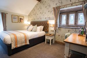 um quarto de hotel com uma cama e uma secretária em The Royal Heysham em Heysham