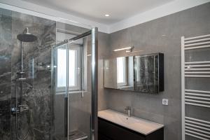 a bathroom with a sink and a shower at Agnanti Sea View Villa in Koskinou +38 photos