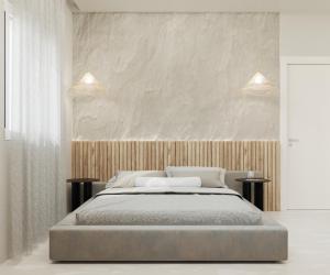 a bedroom with a large bed with two tables at Poema Antiparos in Antiparos