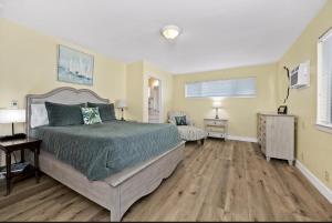 a bedroom with a bed and a desk and a television at Sandy Feet Retreat -- Lakefront Retreat With Sand Volleyball Court! in Clearlake Oaks