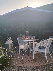 a table and chairs on a patio with a view at La Closeraie Saint Girons in Saint-Girons-dʼAiguevives