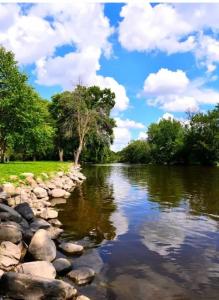 a river with rocks and clouds in the water at Burlington Getaway in Burlington