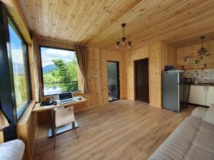 a room with a desk with a computer on it at Villa Machakhela●ვილა მაჭახელა in Batumi