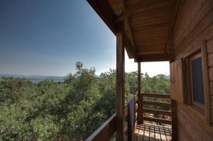 a view from the porch of a wooden cabin with a balcony at ECOLODGE CABAÑEROS 