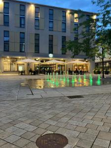 a building with a water fountain in front of it at elaya hotel goeppingen in Göppingen