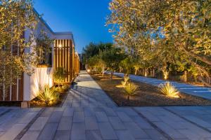 a walkway in a park with trees and lights at Ema'ar Villas in Ulcinj