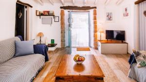 a living room with a couch and a bowl of fruit on a table at The Casita Spain Huercal-Overa by Ruralidays in Los Camachos