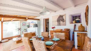 a dining room with a wooden table and chairs at The Casita Spain Huercal-Overa by Ruralidays in Los Camachos