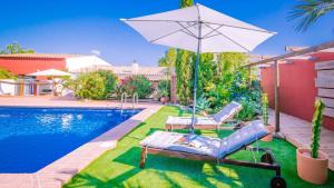 a pool with two lounge chairs and an umbrella at The Casita Spain Huercal-Overa by Ruralidays in Los Camachos