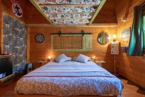 a bedroom with a bed in a wooden room at La Tana dello Scoiattolo in Murazzano
