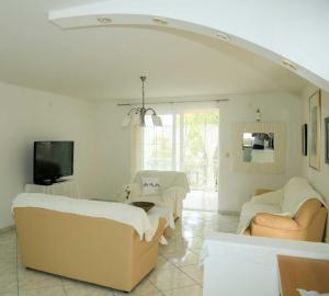 a living room with two couches and a tv at Adrian-Apartments-51511-Malinska-Otok-Krk Primorska 21 in Malinska