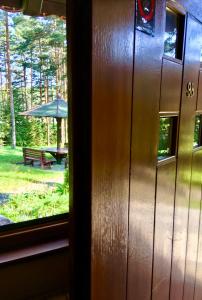 een raam met uitzicht op een park met een picknicktafel en een paraplu bij KRALJEVI KONACI - Vila Zelena Dolina - Zlatibor in Zlatibor