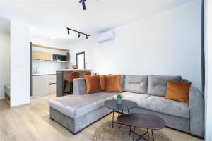 a living room with a couch and a table at Ema'ar Villas in Ulcinj