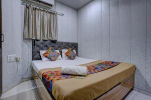 a bedroom with two beds in a room at Hotel Saini,Mumbai in Mumbai