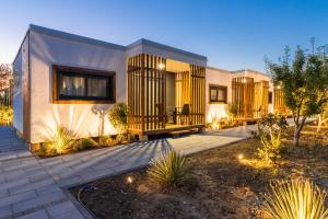 a home with a lit up backyard with a house at Ema'ar Villas in Ulcinj