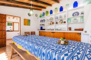 a bedroom with a blue and white bed in a room at Sa Casa des Pintor Miquel Vives 213 in Cala Bona +28 photos