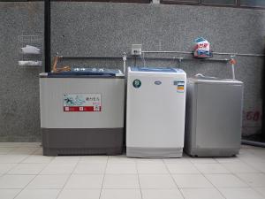 a group of three refrigerators sitting next to a wall at Normans B&B in Hualien City
