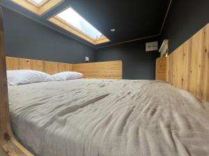 1 dormitorio con 1 cama blanca grande y tragaluz en Hole 37, en Tsukuba