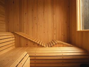 an empty wooden sauna with a window in it at Hole 37 in Tsukuba