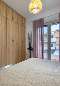 um quarto com uma cama grande e uma janela em Anali Apartment em Ixia