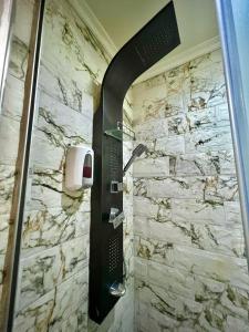 a shower in a bathroom with a stone wall at Riad Dar El Mesk in Rabat +70 photos