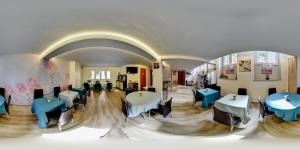 a restaurant with tables and chairs in a room at Hôtel du Parc in Lyon